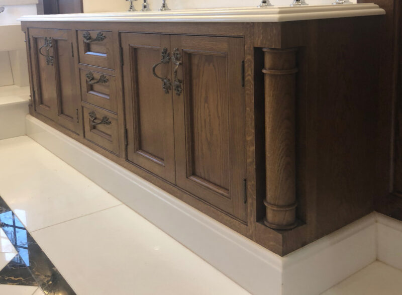 A painted bathroom vanity cabinet with three drawers and four doors, by Old Fashioned Bathrooms