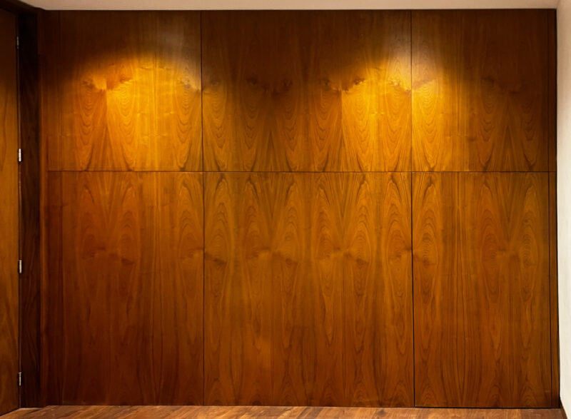 Walnut hall panelling with a jib door concealed in the panel run, by Reeve & Co Interiors