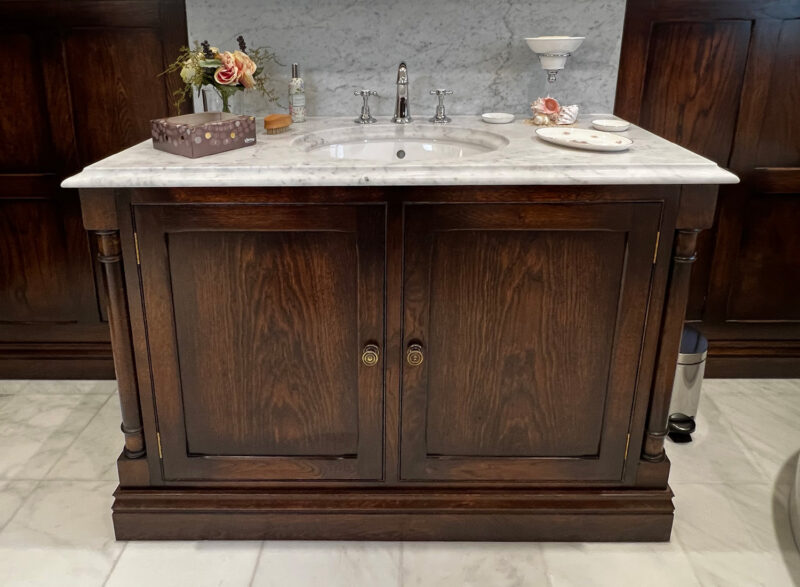 An oak vanity unit with a marble top, by Old Fashioned Bathrooms