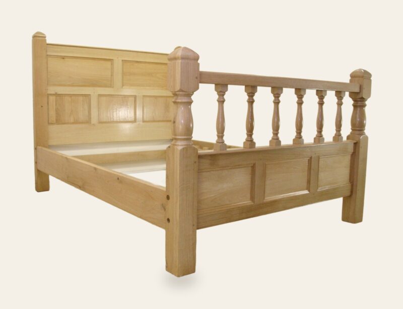 Bed with turned foot board, corner view — handmade by Bryn Hall in Suffolk