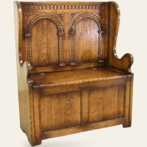 Carved settle, angle view — handmade by Bryn Hall in Suffolk