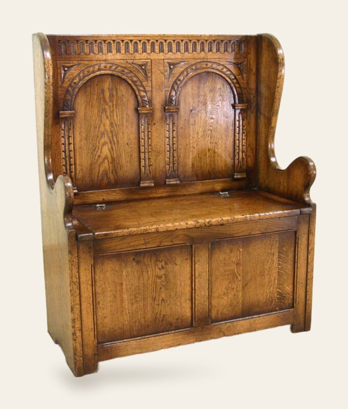 Carved settle, angle view — handmade by Bryn Hall in Suffolk
