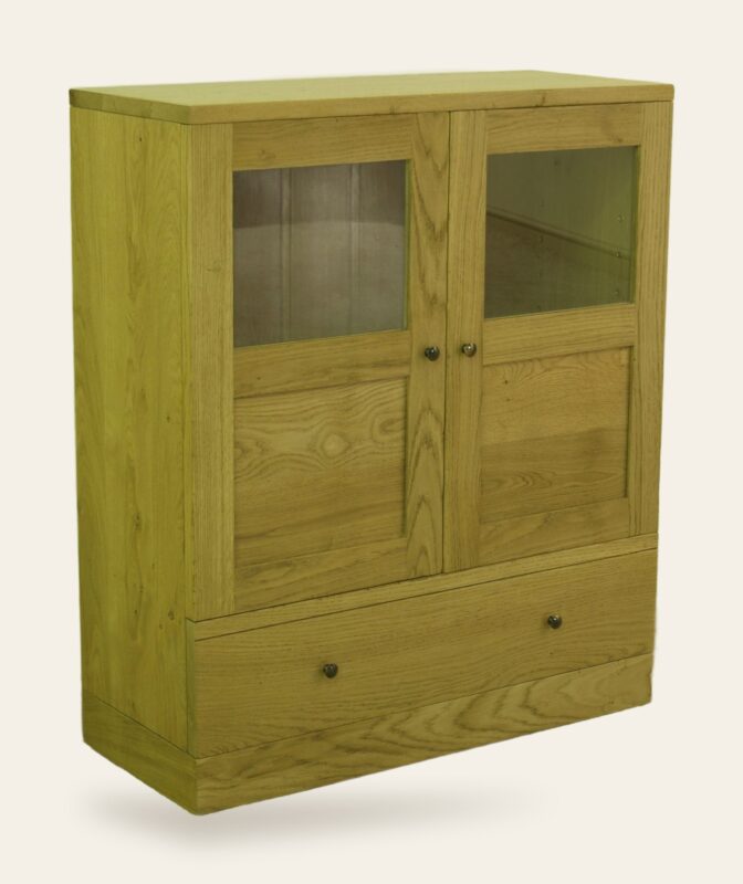 Contemporary two glass door cabinet with one drawer, angle view — handmade by Bryn Hall in Suffolk