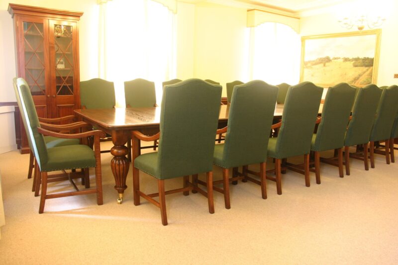 A Victorian-pattern boardroom table on fluted legs with Glendale chairs, made for E’On