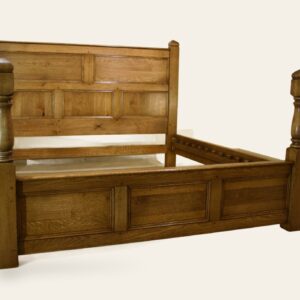 Turned and panelled bed, side view — handmade by Bryn Hall in Suffolk