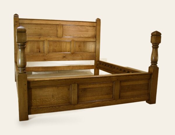 Turned and panelled bed, side view — handmade by Bryn Hall in Suffolk