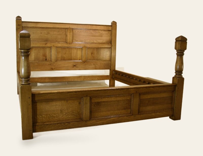 Turned and panelled bed, side view — handmade by Bryn Hall in Suffolk