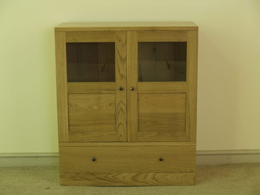 Contemporary two glass door cabinet with one drawer, front view — handmade by Bryn Hall in Suffolk