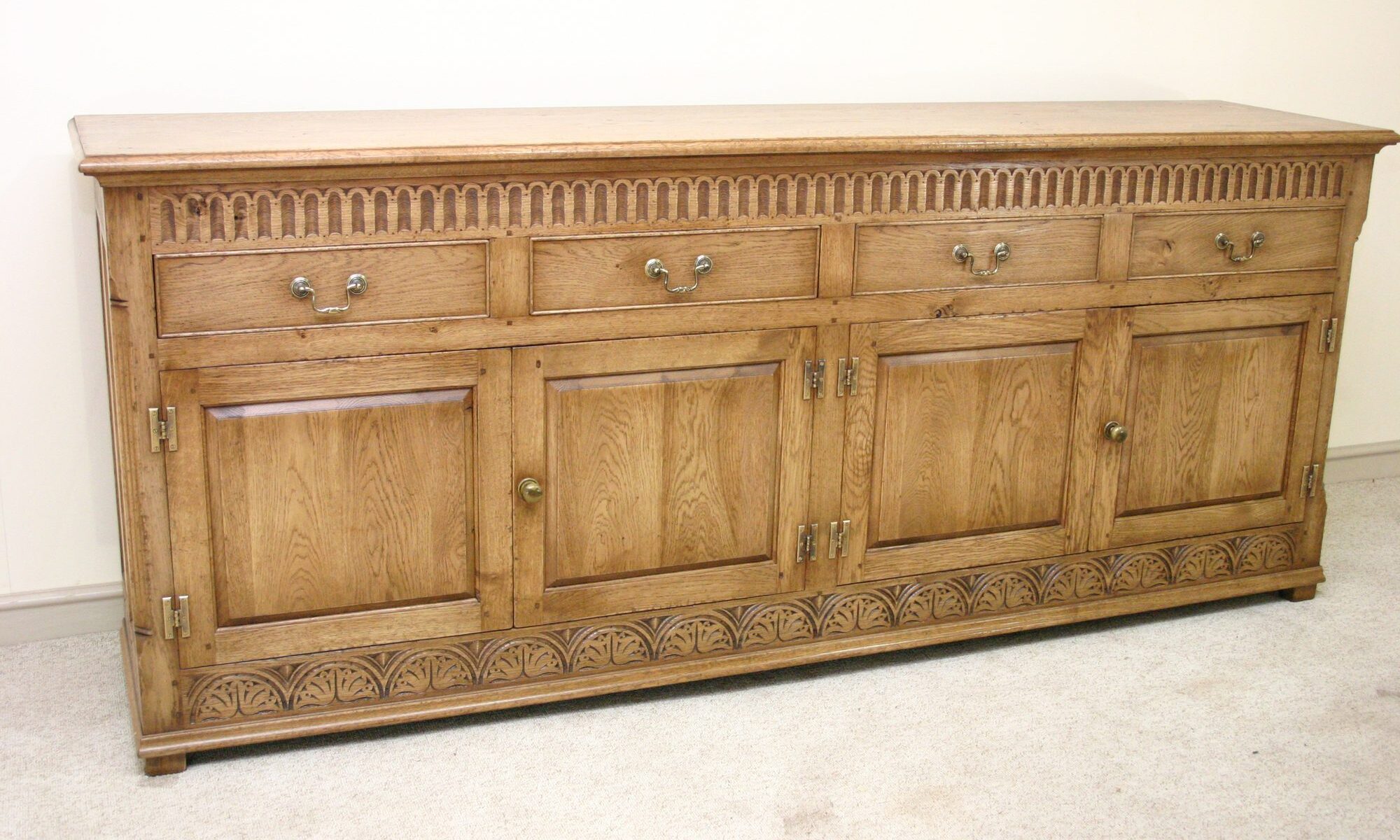 Carved four drawer door dresser, corner view — handmade by Bryn Hall in Suffolk
