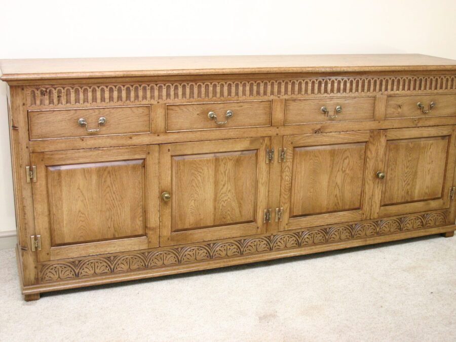 Carved four drawer door dresser, corner view — handmade by Bryn Hall in Suffolk