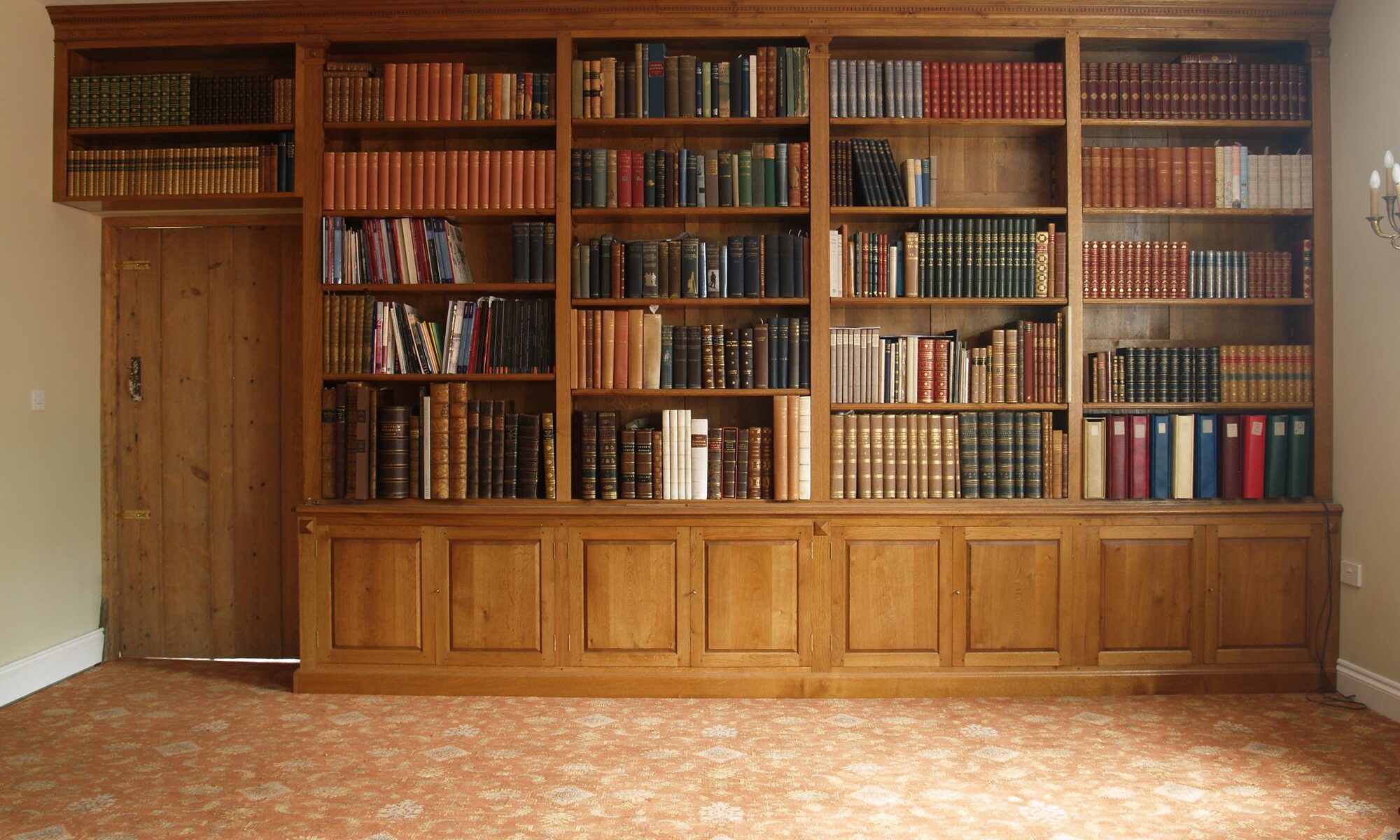 Very large fitted oak bookcase, view 1 — handmade by Bryn Hall in Suffolk