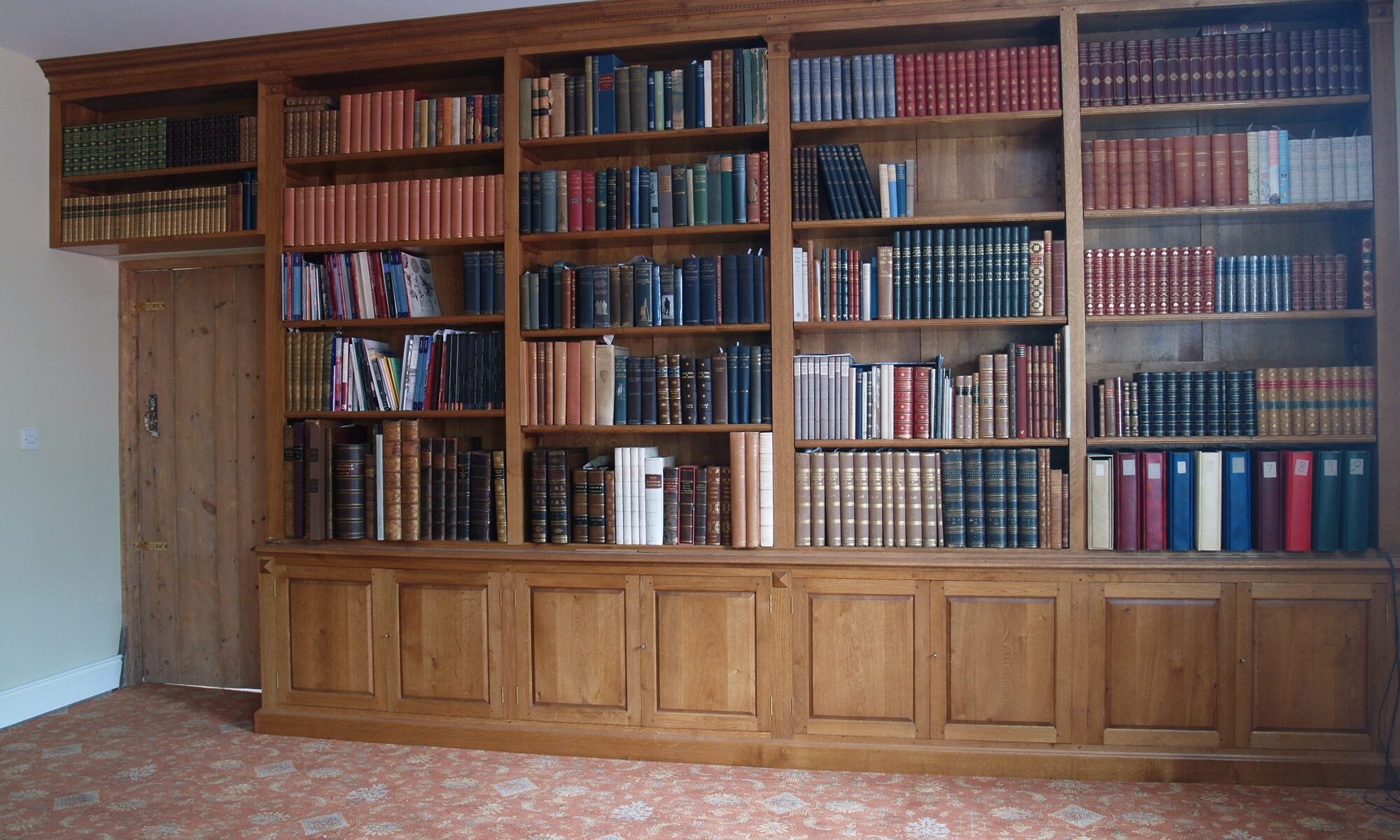 Very large fitted oak bookcase, view 2 — handmade by Bryn Hall in Suffolk