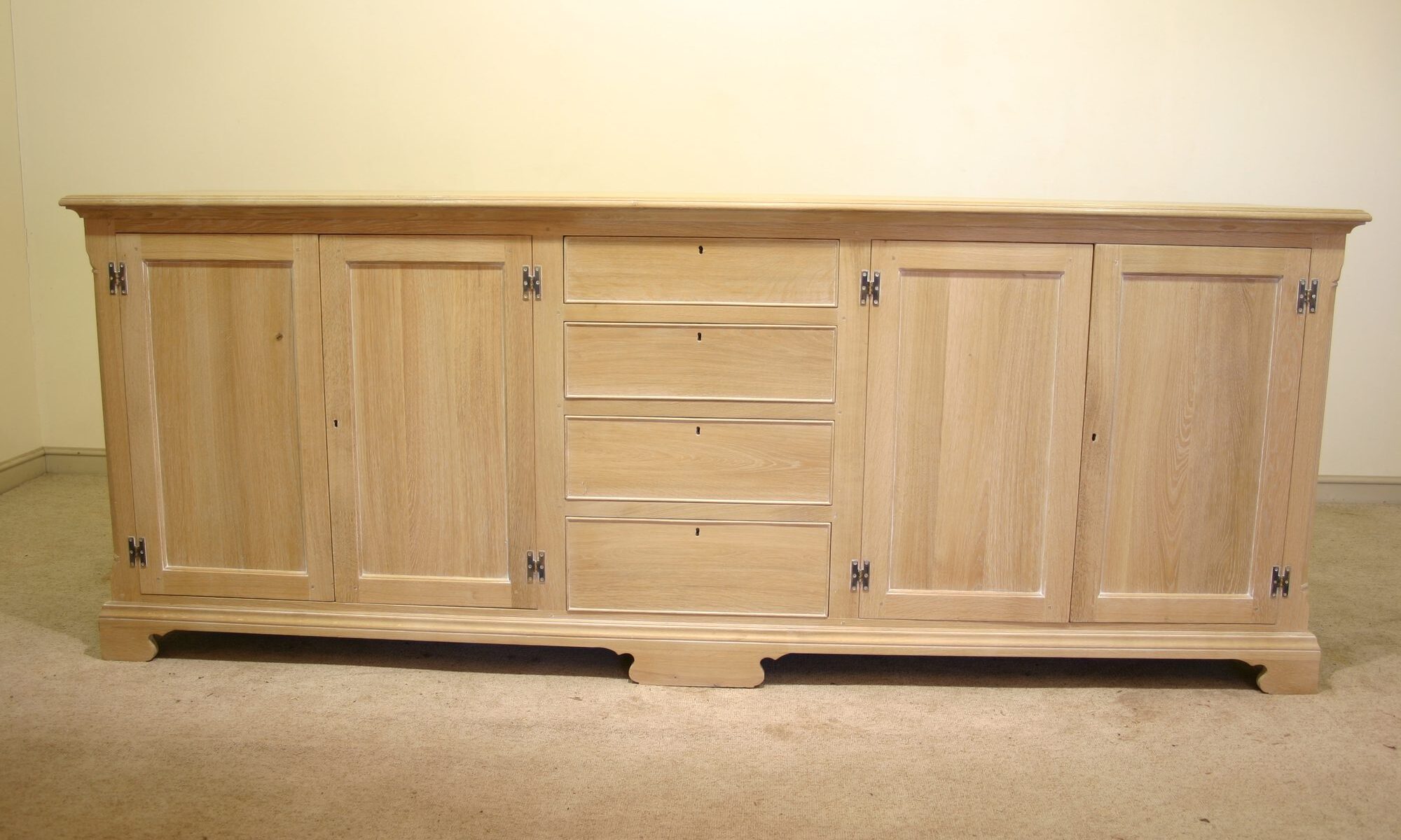 Windrush dresser base four doors and row of four drawers limed oak, front view — handmade by Bryn Hall in Suffolk