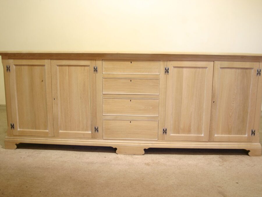 Windrush dresser base four doors and row of four drawers limed oak, front view — handmade by Bryn Hall in Suffolk