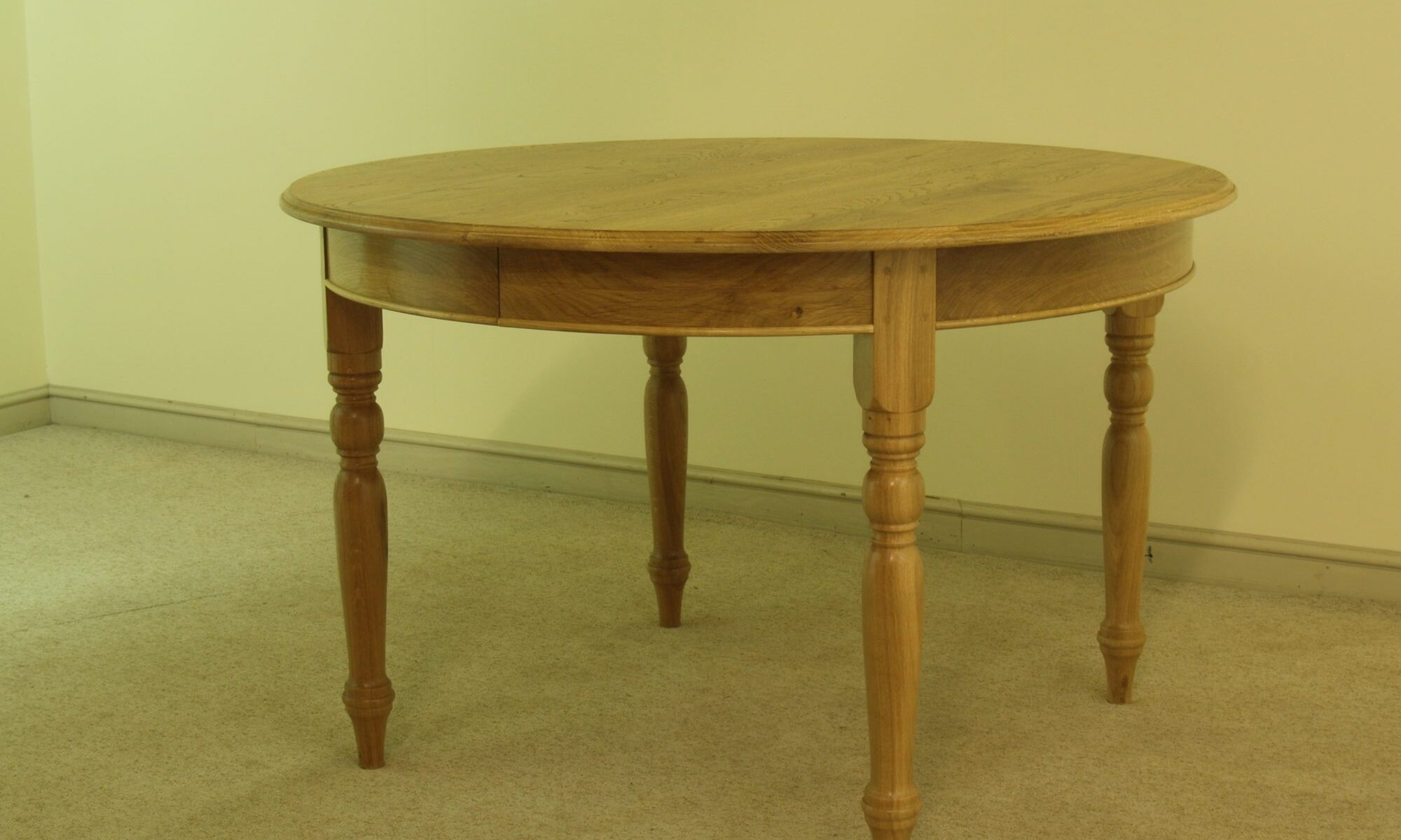 Round kitchen table with two leaves 314a, angle view — handmade by Bryn Hall in Suffolk